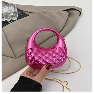 Close-up of pink metallic mini crossbody bag with quilted diamond pattern and gold chain
