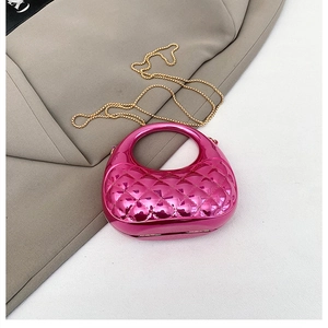 Detail of rose red metallic mini handbag with diamond lattice pattern and gold chain strap