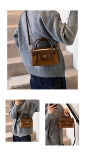 Brown two-tone leather handbag shown in various carrying styles by model on grey stairs