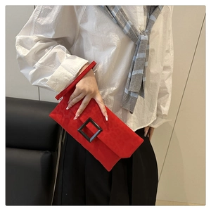 Detail view of red leopard print envelope clutch bag with a black matte square buckle