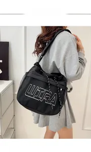 Detail of black mesh tote bag with white ULTRA print and drawstring cord closure