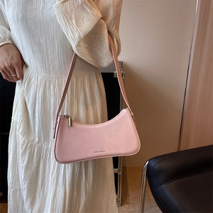 Elegant light pink French baguette shoulder bag paired with a white pleated dress