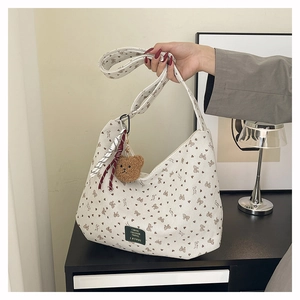 Détail du sac fourre-tout en velours côtelé crème avec motifs cœurs et ours en peluche