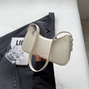 Minimalist white crescent shoulder bag with leather texture and elegant hobo silhouette
