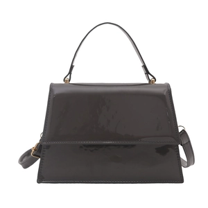 Deep grey glossy patent leather crossbody bag with top handle and gold hardware