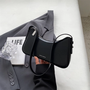 Minimalist black leather underarm bag with silver logo in a stylish business look