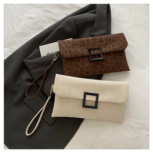 Detail of leopard print and beige envelope clutch bags with decorative square buckles