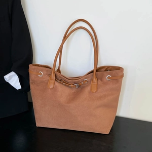 Brown faux suede oversized tote bag with decorative buckle and long shoulder straps