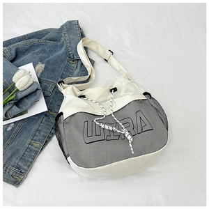 Detail of minimalist canvas tote with black mesh trim and decorative drawstring