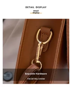 Close-up of premium golden hardware and polished D-ring on the brown leather tote bag