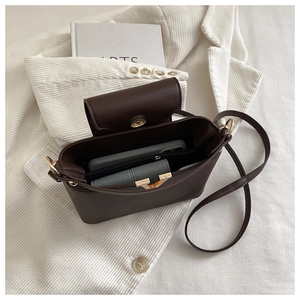 Detail view of the brown lychee pattern leather handbag interior and compartments