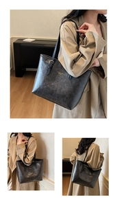 Close-up showing vintage faux leather texture and gold embossed lettering on the tote bag