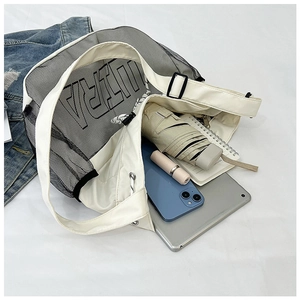 Top view of white mesh tote bag interior showing large storage capacity with daily items