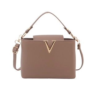 Minimalist taupe bucket bag with gold V-shaped metal buckle and adjustable shoulder strap