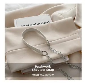 Detail of a white leather and silver metal chain spliced shoulder strap for a handbag