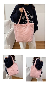 Detail of pink corduroy tote bag featuring a front pocket and soft ribbed texture