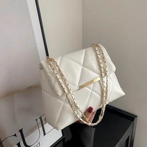 White quilted crossbody bag with gold chain strap and metal clasp in a modern style