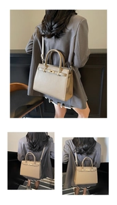 Detail of beige leather bag featuring golden twist lock closure and adjustable strap