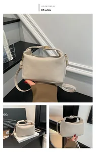 Detailansicht der cremeweißen Kunstledertasche mit goldenen Beschlägen und Tragegriff