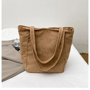 Close-up of brown corduroy tote bag with textured fabric and dual shoulder straps