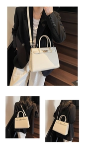 Detail of cream white leather Kelly bag showing gold hardware clasp and shoulder strap