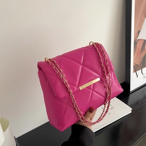 Magenta quilted crossbody bag with gold chain strap and metallic clasp closure