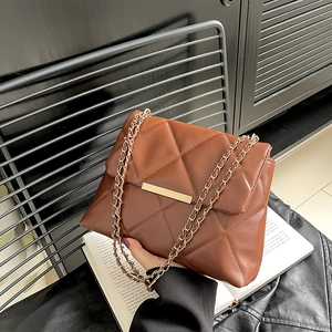 Brown quilted crossbody bag with gold chain strap and metallic closure for women
