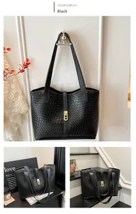 Detail of black woven texture tote bag with golden buckle for urban fashion style
