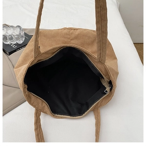 Detail view of khaki corduroy tote bag showing large capacity inner space and zipper pocket