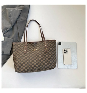 Brown tote bag with M-pattern, gold bow detail, and large capacity for work essentials
