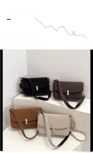 Detailed view of four colorful crossbody bags featuring unique peanut-shaped gold buckles