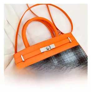 Detailed macro view of the silver twist lock and premium hardware on a plaid handbag