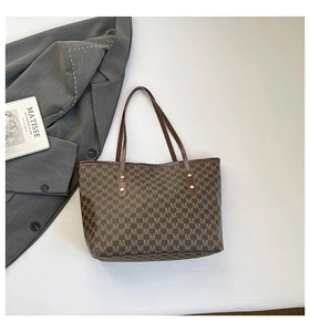 Top-down view of large brown tote bag with M-letter jacquard and leather details
