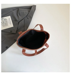 Top view of white woven tote bag interior showing large capacity and zipper closure