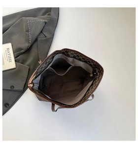 Detail view of large tote bag interior with multiple pockets and retro brown lining