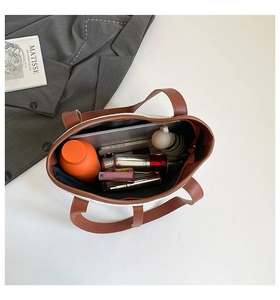Top view of large tote bag interior showing spacious capacity with tablet and essentials