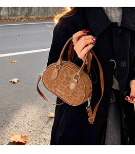 Detail of leopard print mini tote bag with Creative Cat logo on brown suede leather