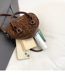 Top view of brown leopard print Boston bag showing spacious interior with personal essentials