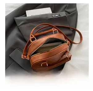 Detailed view of the brown leather shell bag interior and spacious compartment