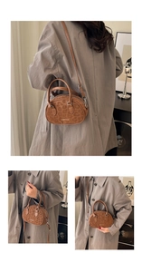 Detail view of brown leopard print crossbody bag with Creative Cat gold logo lettering