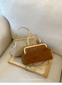 Detailed view of vintage clasp bags with rich rabbit texture and gold round handles