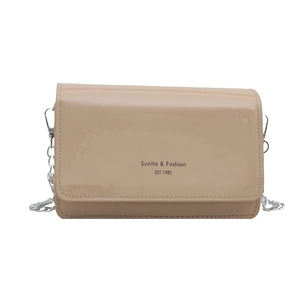 Beige patent leather crossbody bag with silver chain strap and printed lettering