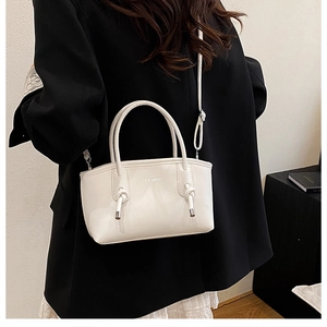 Détail d'un mini sac à main blanc carré avec logo Fashion et bandoulière à nœuds décoratifs