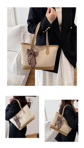 Detail view of a beige canvas tote with brown leather trim and silk scarf ribbon accent