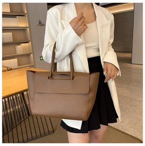 Close-up of premium brown leather tote bag with elegant stitching and handle details