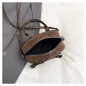 Detail of dark brown leopard print mini crossbody bag with suede texture and thin strap