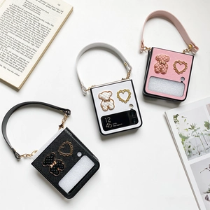 Detail of Samsung Galaxy Z Flip case with diamond bear charm and leather strap