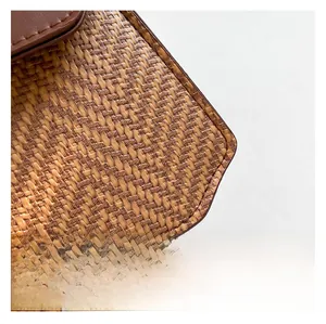 Close-up of contrast straw weave and premium brown leather stitching on a mini bag