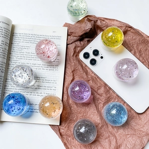 Macro view of colorful crystal ball phone socket with shimmering glitter and liquid foil