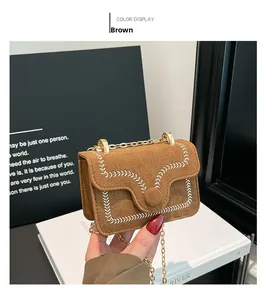 Detailed view of brown suede mini crossbody bag with wheat embroidery and gold chain